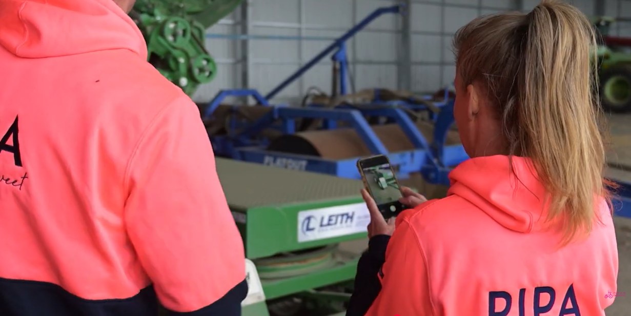 Workers photographing machinery for a safety check